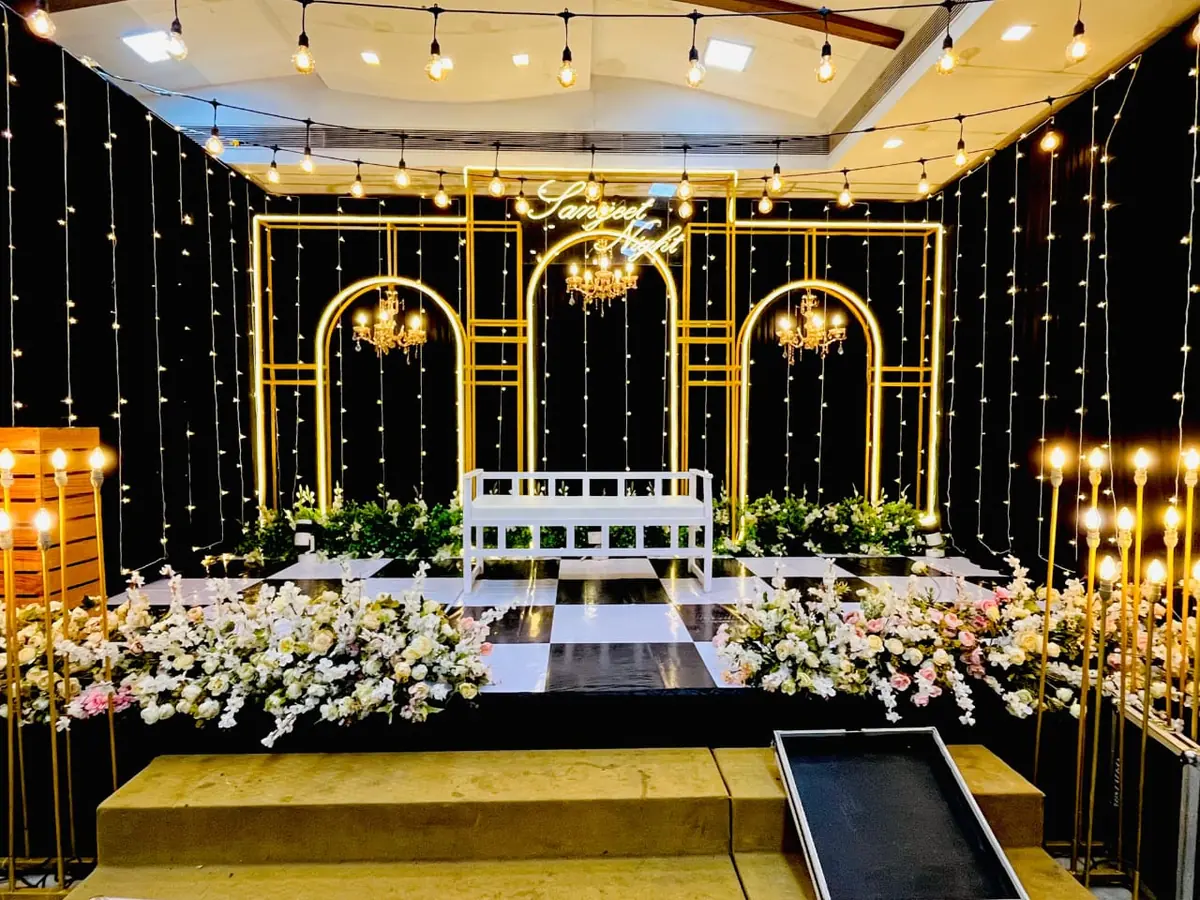 Sangeet night stage with glowing gold arches — Shadhi Catering and Event Management
